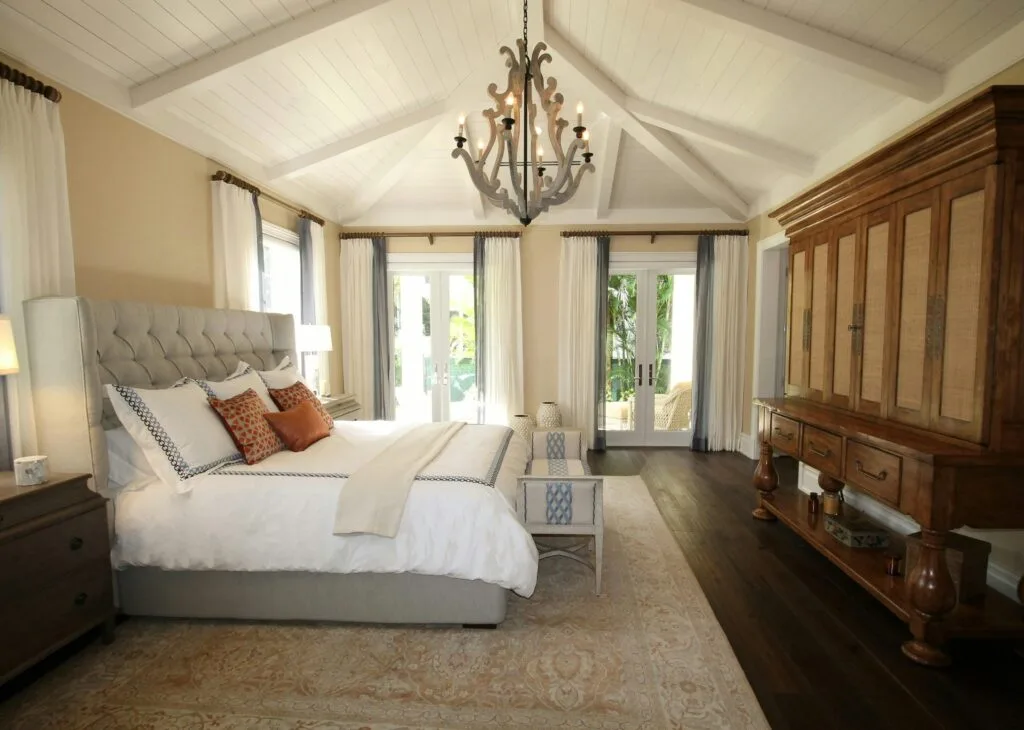 pexels-photo-262048-262048 Stylish bedroom interior featuring a rustic chandelier, cozy bedding, and elegant wooden furniture.